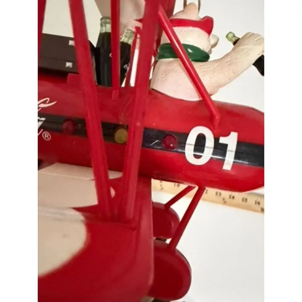 Vtg. Coca cola christmas decoration featuring a polar bear in a red biplane